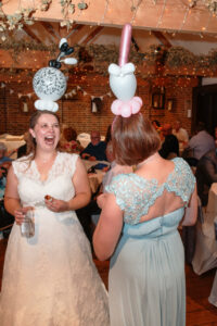 Bride and bridesmaid with Balloons on heads, laughing!